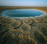 Discs of travertine ring a twelve-foot wide hot spring in the Danakil Depression, Ethiopia.