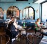The dark timbers at Lola's Level 1 frame the changing light of Bondi outside. 