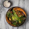 A plant bowl with quinoa, black lentils, pumpkin and preserved lemon tahini.