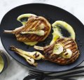 Barbecued pork chops with lemon garlic sauce and pickled spring onions.
