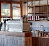 Timber, brass and burnt orange create a feeling of warmth in the cafe.