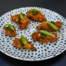 Deep-fried chicken ribs with chimichurri and guindilla peppers.