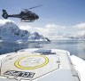 One of two on-board Airbus helicopter lands on the flight deck of Scenic Eclipse in Antarctica.
