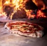 Feeling hot, hot hot: Grossi's simple margherita pizza being cooked in a wood-fired oven.