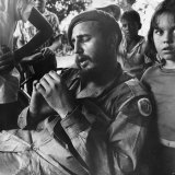 Fidel Castro as Cuban revolutionary leader relaxing at a sugar plantation near Havana, surrounded by children. Communist forces led by Castro overthrew Cuba's US-backed Batista government in 1959.