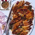 The carved turkey served with summer fruits such as cherries and figs (optional).