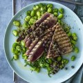 Barbecued tuna steaks with broad beans and olive tapenade.