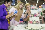 Sweet art: Judges in the esteemed Grand National Wedding Cake Competition check out an entry. 