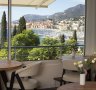 Mirazur's large windows frame a postcard view of Menton's colourful old town cascading towards the harbour.