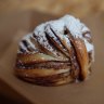 A layered morning bun ready for dipping into coffee.
