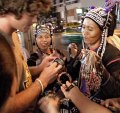 A tourist bargains with a group at a street market in Bangkok, Thailand.
