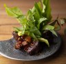 Sticky aged pork surrounded by fresh Thai herbs and leaves. 