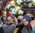 Crowds of people in Covent Garden, London for Christmas, but not everyone wears a mask.