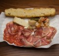 A snacky selection of salumi and cheese with giardiniera pickles.