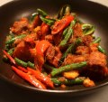 Must-try: Wok-fried pork belly with red curry paste, beans and kaffir lime leaf.