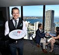 Floor manager Thomas Philbin-Malucelli with a special dessert prepared by the staff of the O Bar and Dining in Sydney's CBD. 