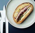 The muffuletta, a pressed baguette of olive, mortadella, salami, ham, provolone, peppers and artichokes.