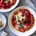 Tomato risotto finished with stracciatella and parmigiano cheeses.