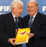 Frank Lowy submits Australia's official bid book for the  Soccer World Cup to Sepp Blatter in 2010.