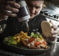 Mr Miyagi cook Matt Schultz prepares their chicken schnitty bao burger and waffle fries, which will be showcased at the Melbourne Night Noodle Market.  