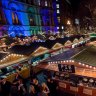 Manchester's Christmas Market with food stalls, bars, Christmas decorations and gift stalls.