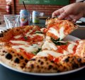 Puffy-crusted margherita pizza.