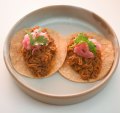 Pork tacos come in pairs.