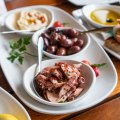 Marinated olives and octopus as part of a Greek feast at Mythos in Oakleigh.