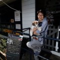 Naoko Okamoto with Douglas out front of Cafe Chew Chew Pet Restaurant, part of a growing trend of eateries catering for dogs. 