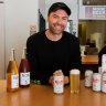 Cameron Walsh, co-owner of Winona bottle shop in Manly, with some of his growing selection of non-alcoholic beer and wine.