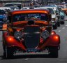 Crowds line Northbourne Avenue for Summernats city cruise in Canberra