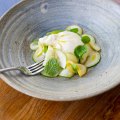 The creamy local burrata is ringed with a delicate zucchini, squash and mint salad.