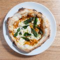 Pizza with pumpkin, stracciatella, pine nuts and fried sage.