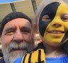 Martin Flanagan and his granddaughter Annie at the footy.