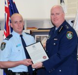 Chris Sheehy (left) receives a bravery award from Newtown Police Commander Simon Hardman in September 2015. The young officer was being covertly monitored during the same period on the  recommendation of his boss. 