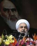 Iranian President Hassan Rouhani delivers a speech under a portrait of the late revolutionary founder Ayatollah Ruhollah Khomeini during a rally to commemorate the anniversary of the 1979 Islamic revolution in Tehran last week.