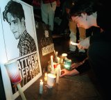 A demonstrator places candles around a picture of Matthew Shepard in New York's Madison Square Park in 1998. 