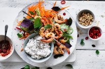 Coconut rice with quick pickled vegetables and prawn skewers.