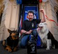 The Great Northern Hotel venue manager and Western Bulldogs supporter Sean Fawsitt with his dogs outside the Carlton pub.
