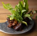 Sticky aged pork surrounded by fresh Thai herbs and leaves. 