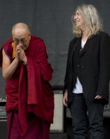US singer Patti Smith on stage with the Dalai Lama.