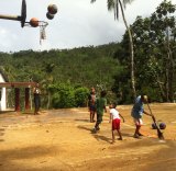 Kids play on a basketball court in Micronesia.