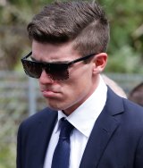 Sean Abbott walks with the procession following Phillip Hughes' funeral in Macksville.