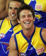 Chris Judd and Ben Cousins smile during a team photo in 2004.