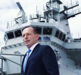 Tony Abbott on the HMAS Canberra Flight Deck before its commissioning ceremony in November 2014.