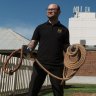 Christopher Anemaat, the gaol's visitor experience officer, shows off one of the hangman's nooses in front of the gallows replica.