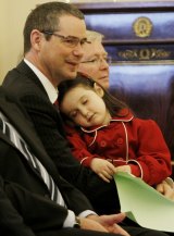 Stephen Conroy holds his daughter Isabella after being sworn in by then Governor-General Quentin Bryce in 2010.