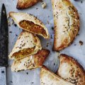 Spiced lentil and vegetable pasties sprinkled with cumin seeds.