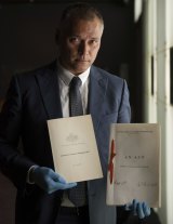 NewsStan Grant, journalist, and member of the Referendum Council examines the original Australian Constitution at the National Archives.