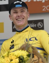 Sky's Chris Froome dons the yellow jersey at the end of the Criterium du Dauphiné on Sunday.